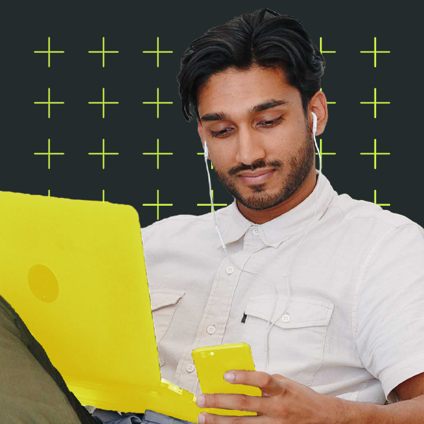 Young adult smiling at their phone