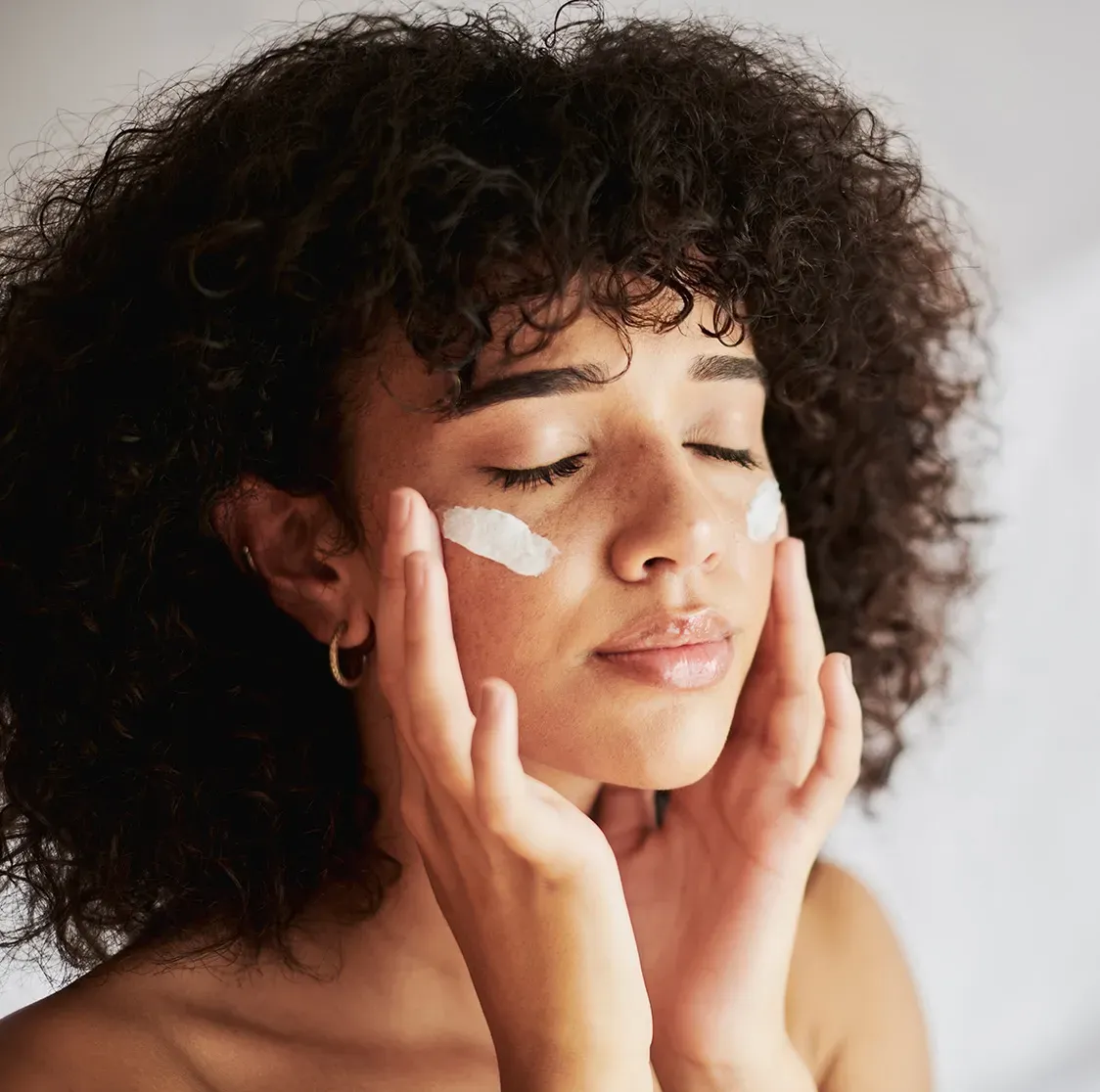 Young woman cleansing her face