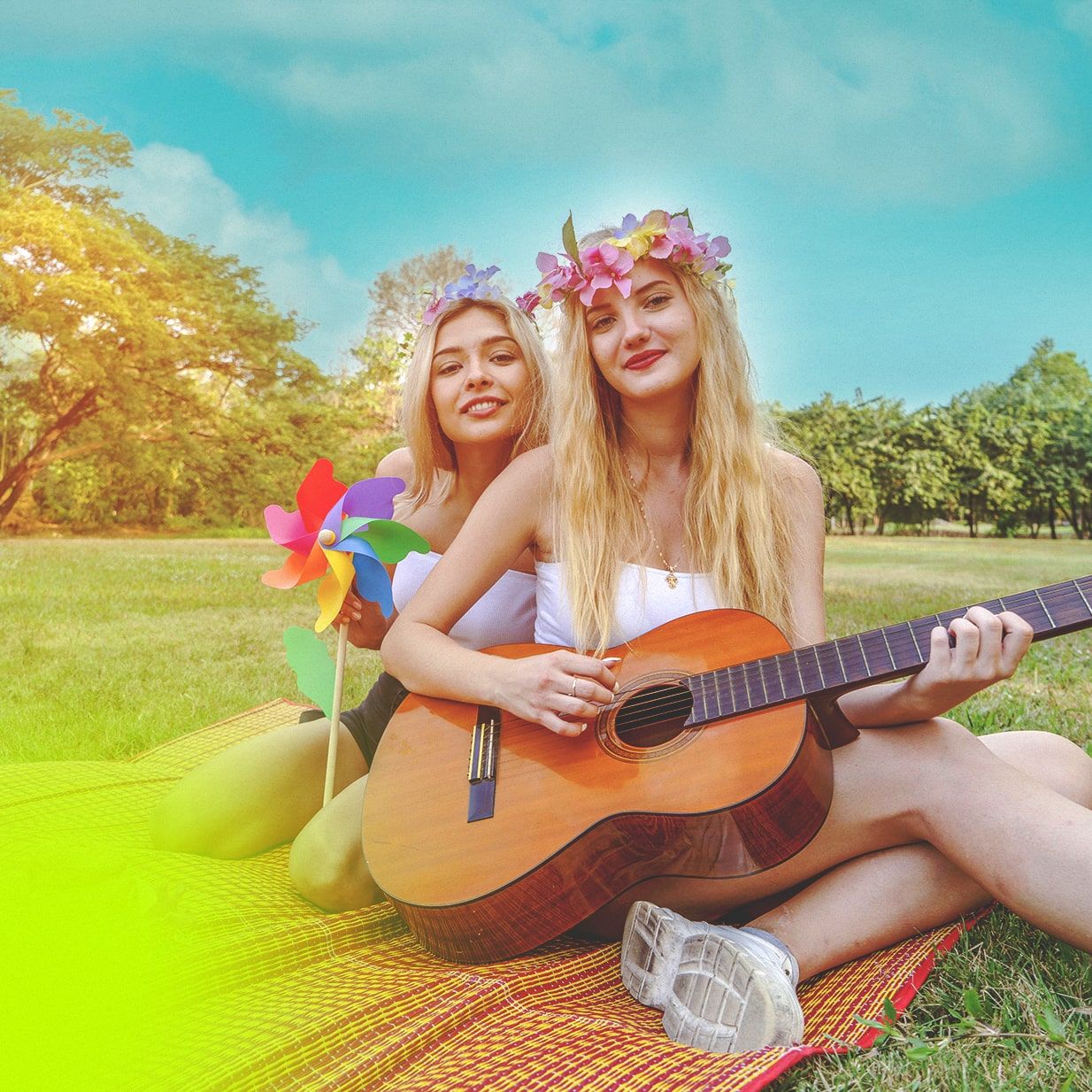 Two friends learning how to play guitar in the park